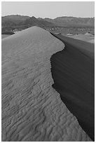 Dune ridge and Amargosa Range at dusk. Death Valley National Park ( black and white)
