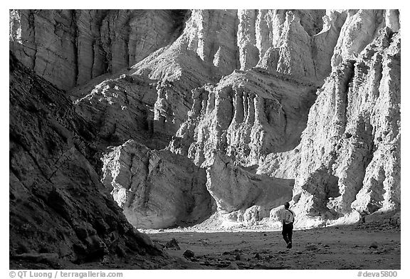 Hikers surrounded by tall walls in Golden Canyon. Death Valley National Park, California, USA.