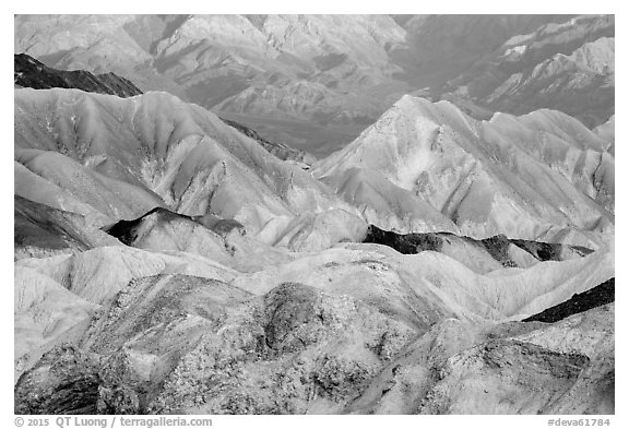 Badlands and mountain lighted by sunrise, Twenty Mule Team Canyon. Death Valley National Park (black and white)