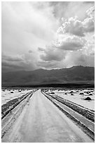 Road crossing Salt Pan. Death Valley National Park ( black and white)