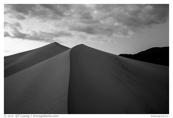 Dune ridges and mountains at sunset, Ibex Dunes. Death Valley National Park (black and white)