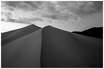 Dune ridges and mountains at sunset, Ibex Dunes. Death Valley National Park ( black and white)