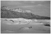 White gyspum sand dunes and cliffs of Guadalupe range at dusk. Guadalupe Mountains National Park ( black and white)