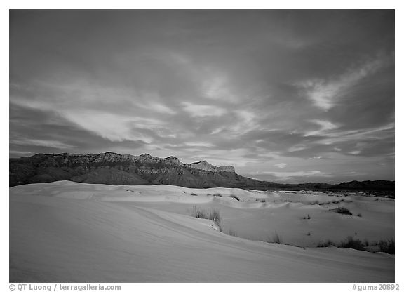 White sand dunes, Guadalupe range, and clouds at sunset. Guadalupe Mountains National Park (black and white)