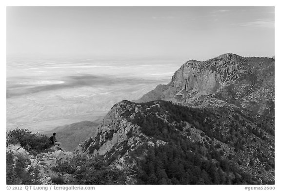 Hiker surveying view over mountains and plains. Guadalupe Mountains National Park, Texas, USA.
