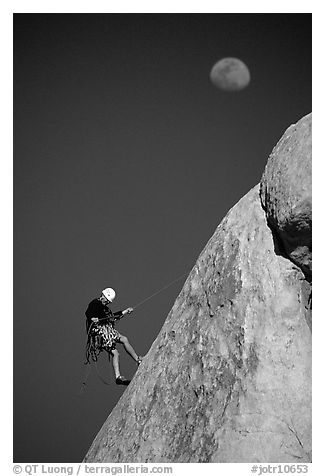 Climber rappelling down with moon. Joshua Tree National Park (black and white)
