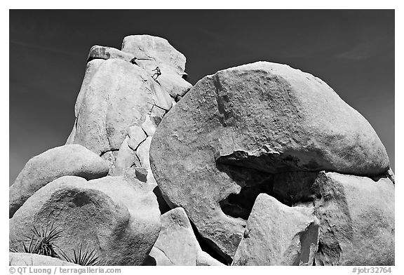 Rocks with climbers in a distance. Joshua Tree National Park, California, USA.