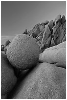 Spherical granite boulder and angular rocks, twilight. Joshua Tree National Park ( black and white)