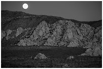 Moon rising about mountains. Joshua Tree National Park ( black and white)