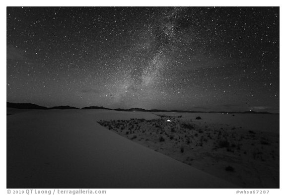 Backcountry camping area with lit tent at night. White Sands National Park (black and white)