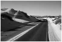 Dunes bordering road. White Sands National Park ( black and white)