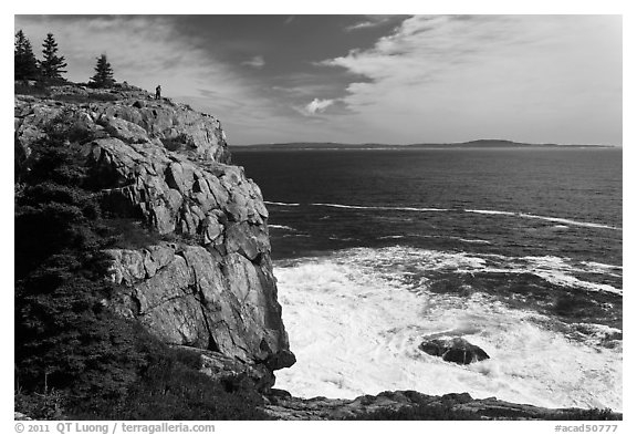 Tall granite sea cliff with person standing on top. Acadia National Park (black and white)