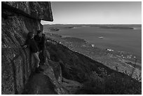 Hikers resting on ledge with handrails. Acadia National Park ( black and white)