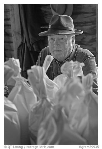 Miller sitting behind bags of cornmeal, North Carolina. Great Smoky Mountains National Park (black and white)