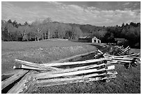 Wooden fence, pasture, and cabin, late afternoon, Cades Cove, Tennessee. Great Smoky Mountains National Park, USA. (black and white)