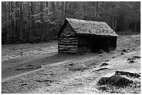 Jim Bales log Cabin in meadow, early morning, Tennessee. Great Smoky Mountains National Park, USA. (black and white)