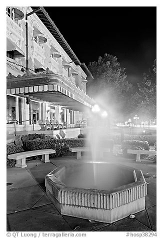 Fountain with thermal steam outside Fordyce Bath at night. Hot Springs National Park (black and white)