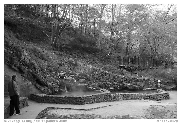 Visitor looking, hot spring cascade. Hot Springs National Park (black and white)