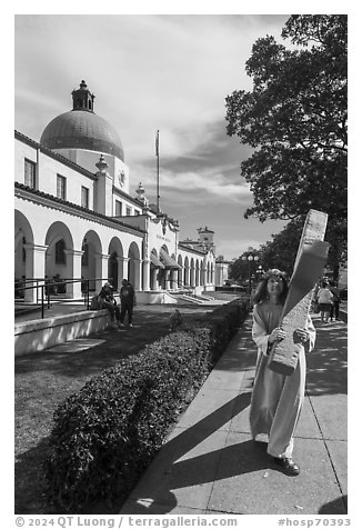 Man dressed as Jesus walking with cross on Bathhouse Row. Hot Springs National Park (black and white)