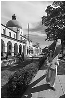 Man dressed as Jesus walking with cross on Bathhouse Row. Hot Springs National Park ( black and white)