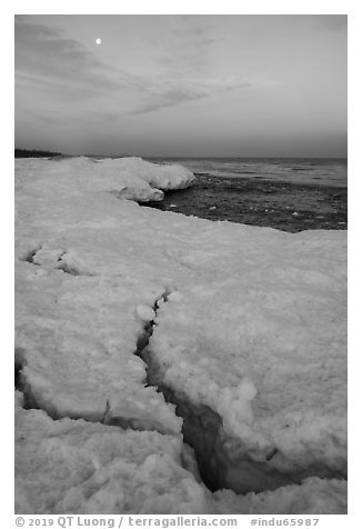 Cracks in shelf ice and moon at dawn, West Beach. Indiana Dunes National Park (black and white)