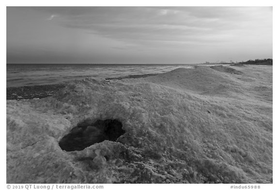 Hole in shelf ice, sunrise, West Beach. Indiana Dunes National Park (black and white)