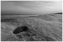 Hole in shelf ice, sunrise, West Beach. Indiana Dunes National Park ( black and white)