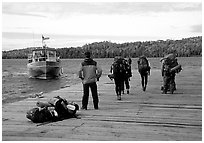 Backpackers waiting for pick-up by the ferry at Windego. Isle Royale National Park, Michigan, USA. (black and white)