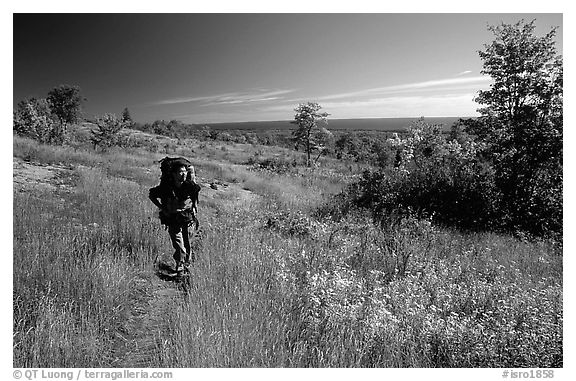 Backpacker walking on Greenstone ridge trail. Isle Royale National Park (black and white)
