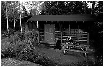 Backpacker sitting in shelter at Chippewa harbor. Isle Royale National Park ( black and white)