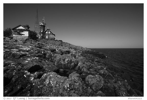 Lichen-covered rocks and Lighthouse, Passage Island. Isle Royale National Park (black and white)