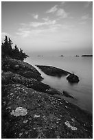 Lichen-colored rocks on Rock Harbor shore, sunset. Isle Royale National Park ( black and white)