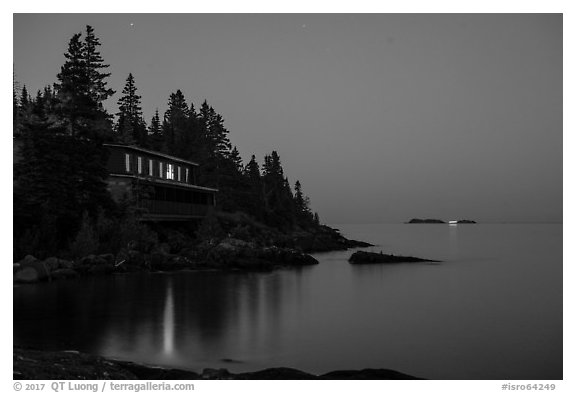Rock Harbor Lodge at night with di Rock Harbor Lodge and moon at duskstant ship in shipping lane in front of Passage Island. Isle Royale National Park (black and white)