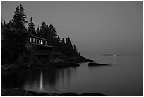 Rock Harbor Lodge at night with di Rock Harbor Lodge and moon at duskstant ship in shipping lane in front of Passage Island. Isle Royale National Park ( black and white)
