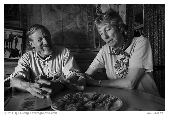 Rolf Peterson and Carolyn Peterson with plate of rhubarb pie in their home. Isle Royale National Park (black and white)