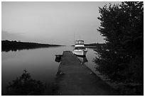 Moskey Basin dock with motorboat and ycaht, dusk. Isle Royale National Park ( black and white)