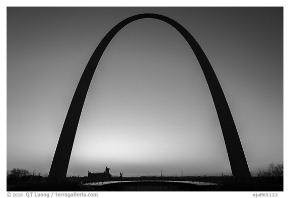 Arch at sunrise with curve of new visitor center roof. Gateway Arch National Park (black and white)