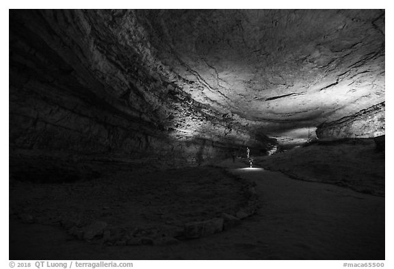 Visitors walk down huge corridor in cave. Mammoth Cave National Park (black and white)