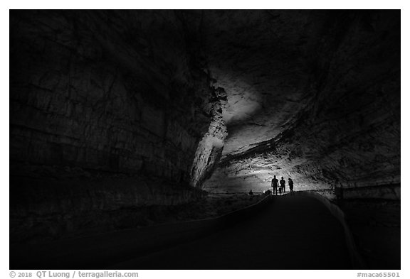 Family backlighted in dark cave corridor. Mammoth Cave National Park (black and white)