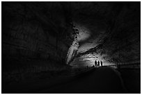 Family backlighted in dark cave corridor. Mammoth Cave National Park ( black and white)