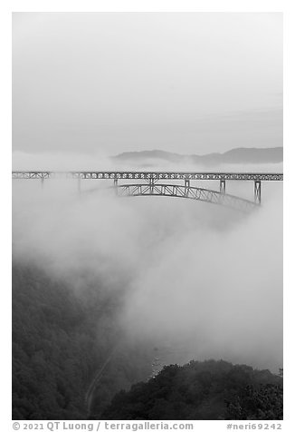 New River Gorge Bridge emerging from fog at dawn. New River Gorge National Park and Preserve (black and white)