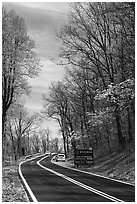 Skyline drive with cars and Park entrance sign. Shenandoah National Park, Virginia, USA. (black and white)