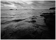 Lakeshore with eroded granite slab and clouds. Voyageurs National Park ( black and white)