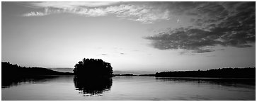 North woods tree-covered isled at sunset. Voyageurs National Park (Panoramic black and white)