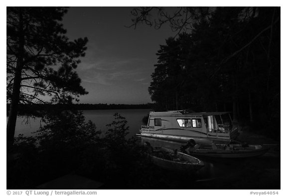 Houseboat lit from within at night, Sand Point Lake. Voyageurs National Park (black and white)