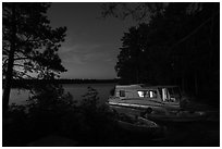 Houseboat lit from within at night, Sand Point Lake. Voyageurs National Park ( black and white)