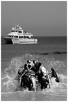 Skiff crossing  surf to join tour boat, Cuyler harbor, San Miguel Island. Channel Islands National Park, California, USA. (black and white)