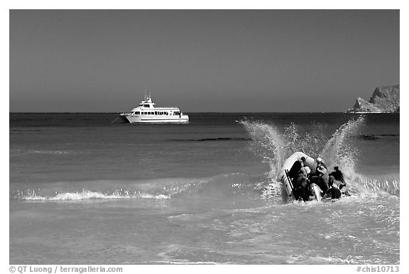 Skiff going back to main boat through surf, Cuyler harbor, San Miguel Island. Channel Islands National Park (black and white)