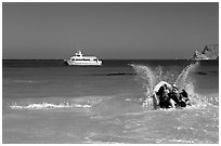 Skiff going back to main boat through surf, Cuyler harbor, San Miguel Island. Channel Islands National Park, California, USA. (black and white)