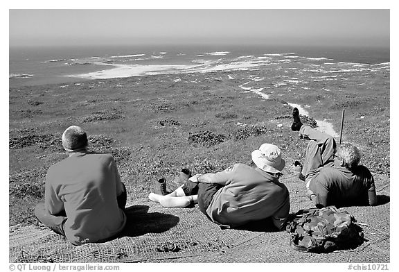 Hikers observing Point Bennett from a distance, San Miguel Island. Channel Islands National Park, California, USA.